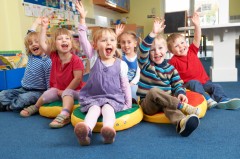 Children with hands up in the air